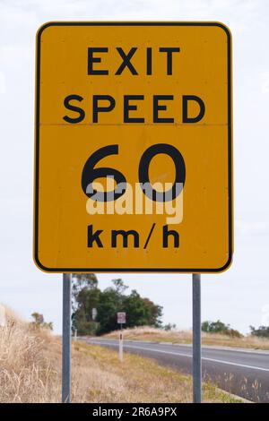 Australian exit sign highway showing speed 60 km/h with black lettering and yellow painted metal background, Victoria, Australia. Stock Photo