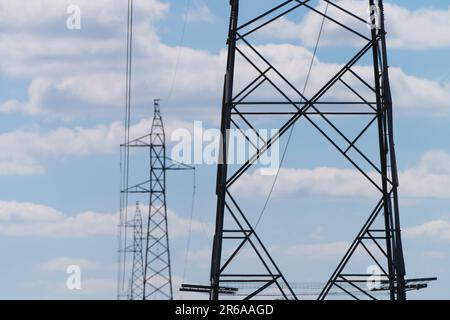 High voltage electricity pylons in a landscape background with cloudy sky, Victoria, Australia. Stock Photo