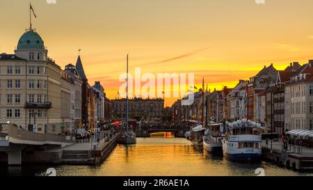 Denmark, Copenhagen - 15 May 2019: Nyhavn at night. A 17th-century waterfront, canal and entertainment district with brightly colored townhouses, bars Stock Photo
