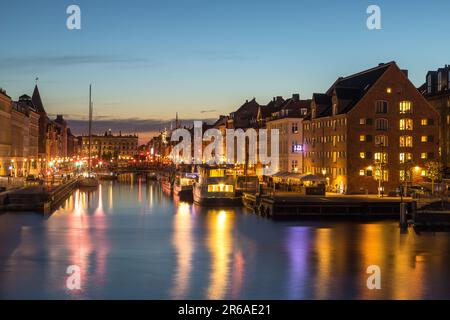 Denmark, Copenhagen - 15 May 2019: Nyhavn at night. A 17th-century waterfront, canal and entertainment district with brightly colored townhouses, bars Stock Photo