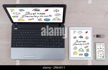 Business development concept shown on different information technology devices Stock Photo