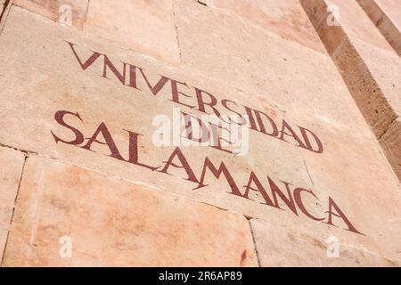 Salamanca University, view of the historic inscription sited on the characteristic pink sandstone wall of the university building in Salamanca, Spain Stock Photo