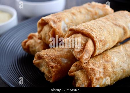 Egg rolls on a black plate Stock Photo