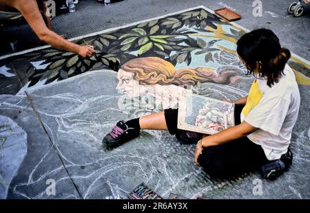 Two street artists painting Boticelli's The birth of Venus, in the streets of Florence, Italy. Stock Photo
