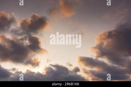 evening sky in orange glow. huge fluffy clouds. dramatic natural background Stock Photo