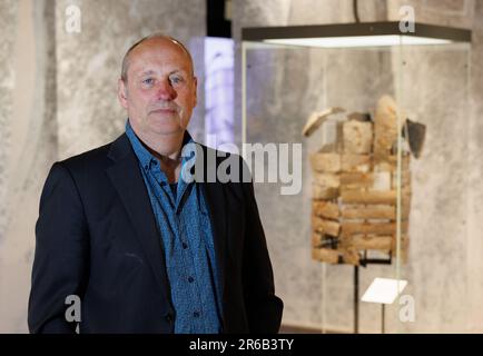 Bramsche, Germany. 08th June, 2023. Stefan Burmeister, managing director, stands next to a Roman rail tank (9 AD). In 2018, the Varus Battle Museum in Kalkriese found a Roman rail tank during excavations - according to the museum, the oldest so far and the only one preserved worldwide. The museum is showing further exhibits on this in the special exhibition 'Cold Case - Death of a Legionnaire' from June 10 to Nov. 5, 2023. Credit: Friso Gentsch/dpa/Alamy Live News Stock Photo