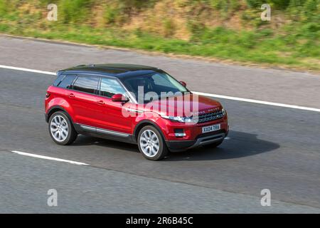 2014 Red Land Rover Range Rover Evoque Pure T; travelling at speed on the M6 motorway in Greater Manchester, UK Stock Photo