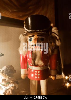 This stock photo features two beautiful wooden Christmas ornaments, one of which is a traditional nutcracker Stock Photo