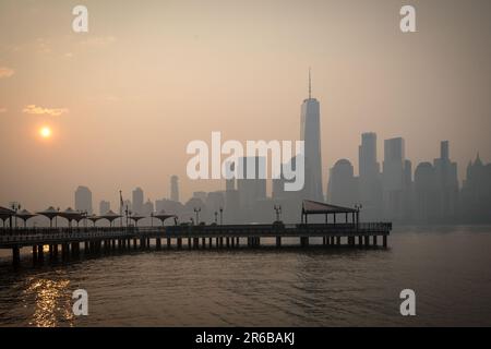The sun rises behind the One World Trade Center, while the smoke from Canada wildfires covers the Manhattan borough as it is seen from Liberty State Park on June 8, 2023 in New Jersey. ( Credit: Brazil Photo Press/Alamy Live News Stock Photo