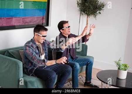 Young lgtbi couple playing and having fun with virtual reality. Concept: technology, pride, couple Stock Photo