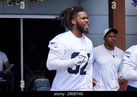 Seattle Seahawks linebacker Boye Mafe, center, works with Aaron Curry,  right, assistant defensive line and defensive ends coach, as linebackers  Tyreke Smith, left, and Joshua Onujiogu, second from left, during NFL  football