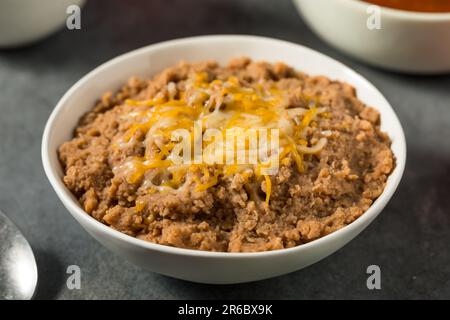 Mexican Homemade Refried Beans with Shredded Cheese Stock Photo - Alamy
