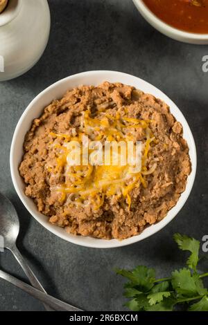 Mexican Homemade Refried Beans with Shredded Cheese Stock Photo - Alamy
