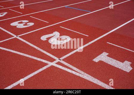 Sports race track with lane and number markings. Rubber surface of athletics running track in public sports arena Stock Photo