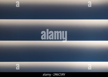 Sunlight through high-end 3.5"-wide wooden plantation shutters. Cinematic close-up. Stock Photo