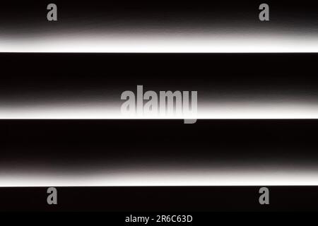 Dramatic cinematic sunlight through high-end 3.5"-wide wooden plantation shutters. Horizontal. Stock Photo
