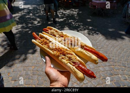 german bavarian hot dog in viktualienmarkt munich with sauerkraut street food . Stock Photo