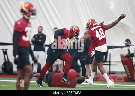 Pro Football Hall of Famer Warren Sapp, center, falls as he