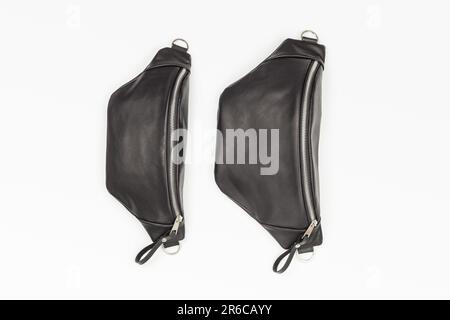 Two Sizes of Black Leather Waist Bag on White Background Stock Photo