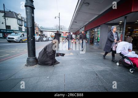 LONDON, MARCH 2023: A homeless man begging on the street of Brixton in south west London