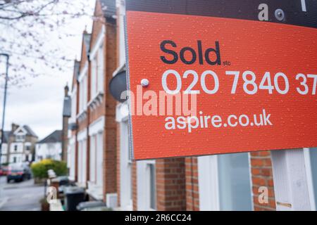 LONDON- MARCH, 2023: Estate Agent sold signs on residential street in south London Stock Photo