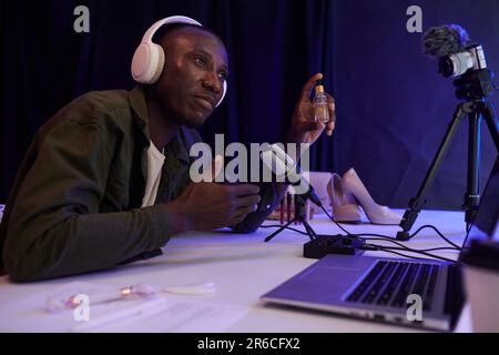 Black man recording his opinion on female beauty products, cosmetics and shoes Stock Photo