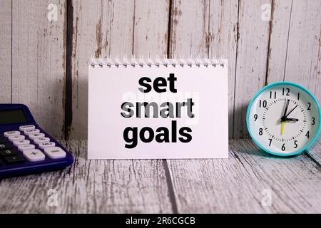 Set smart goals symbol. Concept words Set smart goals on wooden blocks. Beautiful yellow background. Businessman hand. Business and Set smart goals co Stock Photo
