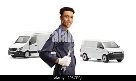 African american auto mechanic holding a wrench and standing in front of two vans isolated on white background Stock Photo