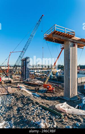 View of pedestal or support for highway ramp under construction.  Shows concrete being poured for second pedestal in the background. Stock Photo