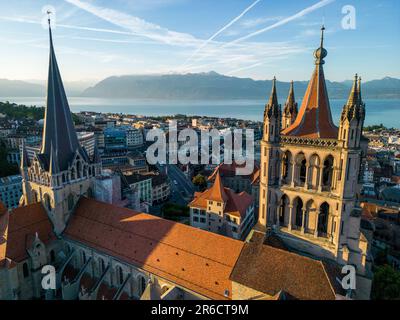 Lausanne, Switzerland, August 22nd 2022. An aerial drone shot of Lausanne cathedral, the city centre, and Lake Geneva at sunrise. Stock Photo