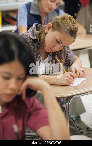 female student taking an Iexam in class Stock Photo