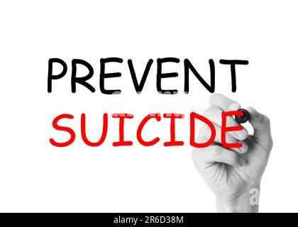 Man writing phrase Prevent Suicide on glass board against white background, closeup. Black and white photo with red color accent Stock Photo
