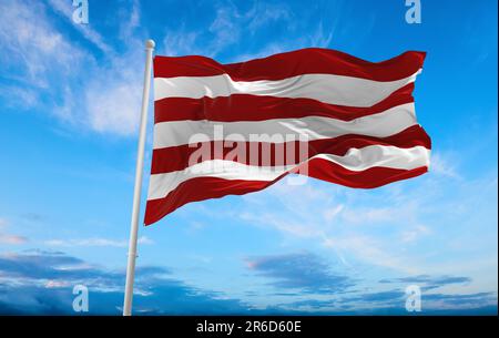 flag of Indo-Aryan ethnoreligious groups Sarnaists at cloudy sky background, panoramic view. flag representing ethnic group or culture, regional autho Stock Photo