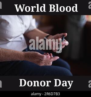 Composite of world blood donor day text and midsection of caucasian senior woman testing sugar Stock Photo