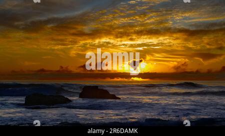 Sunset red clouds over the coast line. Stock Photo