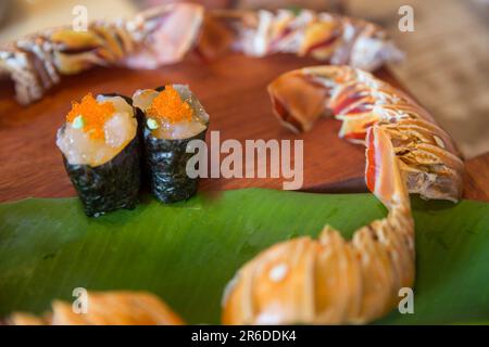 fresh lobster sushi with lobster tails going around Stock Photo