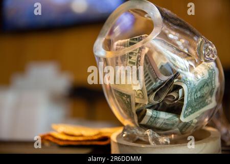 tip jar at a sushi bar with money Stock Photo