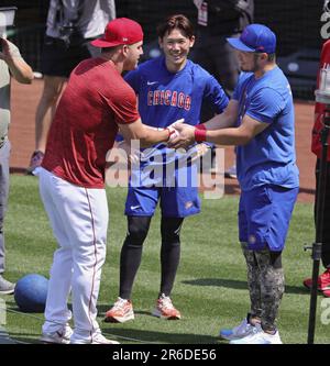 The Chicago Cubs' Seiya Suzuki (R) is congratulated by first base coach  Mike Napoli after hitting an RBI single in the fourth inning of a baseball  game against the Pittsburgh Pirates on