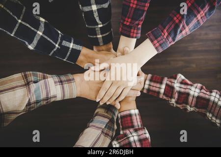 group of like-minded people cupping their palms together Stock Photo