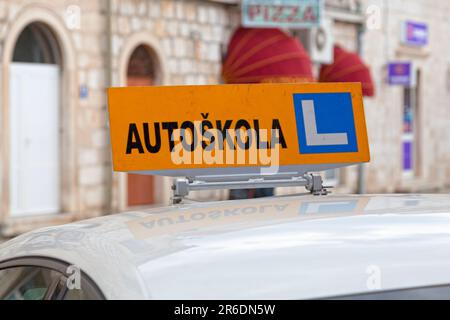Car roof sign with written in it in Croatian 'Autoškola', meaning in English 'Driving school'. Stock Photo