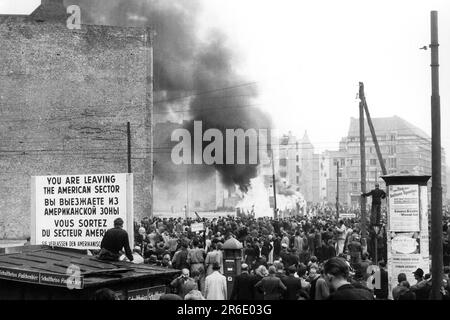 FILED - 17 June 1953, Berlin: View from the American sector into East Berlin's Friedrichstrasse, where a control house of the People's Police is in flames. On June 17, 1953, a million people in the GDR protested against the still young socialist state - until Soviet tanks ended the uprising. Dramatic days. (to dpa 'When the tanks rolled: 70 years after the popular uprising in the GDR') Photo: Günter Bratke/dpa Stock Photo