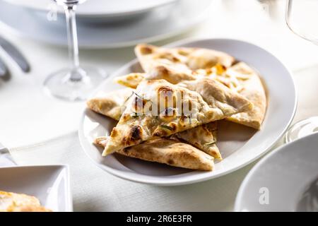 Focaccia flatbread slices with rosemary freshly baked and sliced to triangles Stock Photo