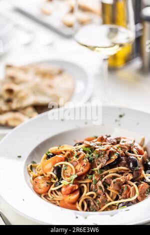 All amatriciana spicy spaghetti with olives, pecorino cheese and tomatoes. Stock Photo