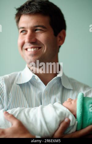 A father holds his new born daughter the day after she was born Stock ...