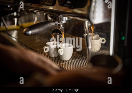 Espresso machine pouring coffee in white cups Stock Photo