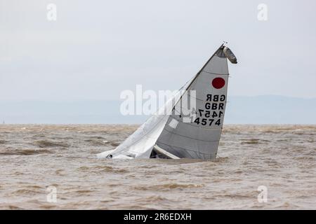 Righting a capsized dinghy on a choppy sea Stock Photo