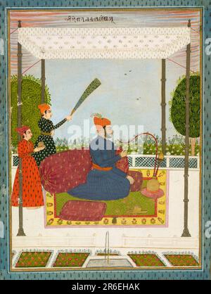 Dressed in an ink blue jama and a rich orange turban with a matching wave-patterned (leheriya) sash (patka), Nawal Singh sits beneath a cool white canopy. An enormous amber-colored bolster with gold leaf-shaped motifs supports him. Suitable to his status, attendants wait on him and one waves a peacock feathered fly-whisk (morchal), a symbol of royalty. Date: ca. 1750. Opaque watercolor and gold on paper. Origin: Datia, Madhya Pradesh state, India. Museum: Freer Gallery of Art and Arthur M. Sackler Gallery. Stock Photo