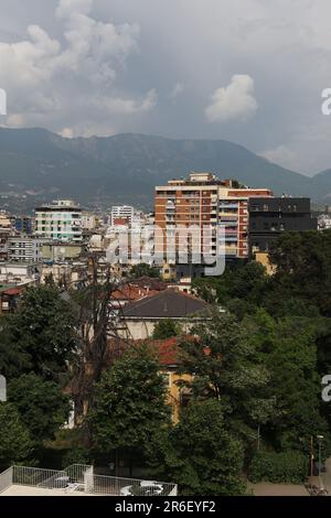 In the distance above the Tirana skyline Dajti (Albanian: Mali i Dajtit) standing at 1,613 m (5,292 ft) above sea level, is a mountain and national park range on the edge of Tirana, Albania. The Dajti belongs to the Skanderbeg range. In winter, the mountain is often covered with snow and is a popular retreat for the local population of Tirana, which rarely sees snowfall. Its slopes have forests of pines, oak and beech, while its interior contains canyons, waterfalls, caves, a lake, and an ancient castle. Stock Photo