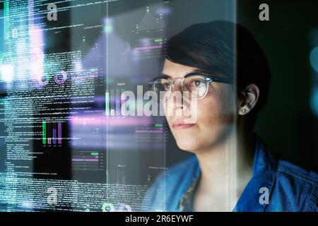 Night, code and hologram with woman in office for programming, future and software development. Big data, networking and technology with female Stock Photo