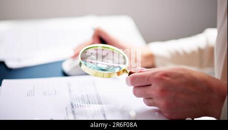 Corporate Auditor Using Magnifying Glass For Tax Fraud Audit Stock Photo